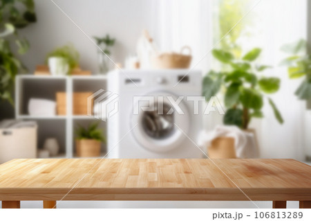 Empty wooden board with towels on blurred background of washing machine in home laundry. Place for product mounting and advertising Empty wooden board with towels on blurred background of washing machine in home laundry. Place for product mounting and advertising 106813289