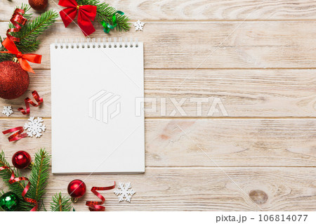 Christmas blank greeting card mock-up scene. Creative layout made of Christmas tree branches and paper card note. Flat lay. Nature New Year concept Christmas blank greeting card mock-up scene. Creative layout made of Christmas tree branches and paper card note. Flat lay. Nature New Year concept 106814077