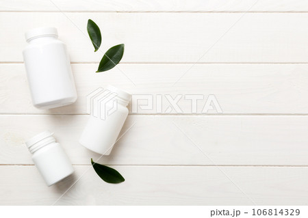 supplement pills with medicine bottle health care and medical top view. Vitamin tablets. Top view mockup bottle for pills and vitamins with green leaves, natural organic bio supplement, copy space supplement pills with medicine bottle health care and medical top view. Vitamin tablets. Top view mockup bottle for pills and vitamins with green leaves, natural organic bio supplement, copy space 106814329