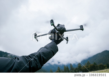 Flying drone in high altitude mountains Flying drone in high altitude mountains 106819501