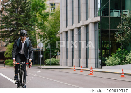 Young manager comuting to the office by electic scooter Young manager comuting to the office by electic scooter 106819517