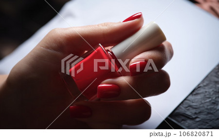 Stylish bright red lacquer on female nails concept 106820871
