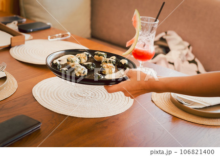 Waiter served fresh food at indoors restaurant. Waiter served fresh food at indoors restaurant. 106821400