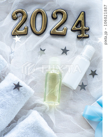 Christmas composition with 2024, towels, giftbox and body care products 106821887