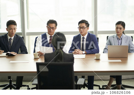young asian job seeker being interviewed by a group of corporate business executives 106826106