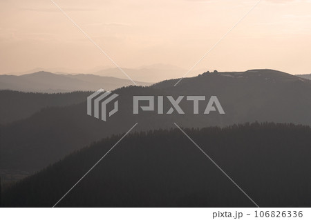 Golden sunset in mountain landscape. Layers of mountains background. Silhouette of the evening mountains at sunset. Golden sunset in mountain landscape. Layers of mountains background. Silhouette of the evening mountains at sunset. 106826336