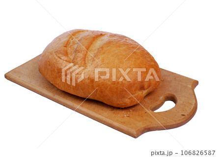 Bread lies on a wooden cutting board on a white background. Bread lies on a wooden cutting board on a white background. 106826587