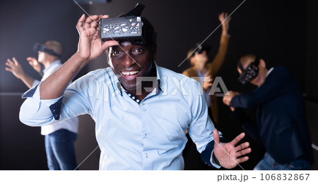 Multicultural friends using virtual reality headsets Multicultural friends using virtual reality headsets 106832867
