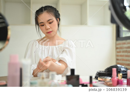 Cute young woman beauty make up artist or vlogger recording makeup tutorial in home studio. Lifestyle, influencer, blogger concept 106839139