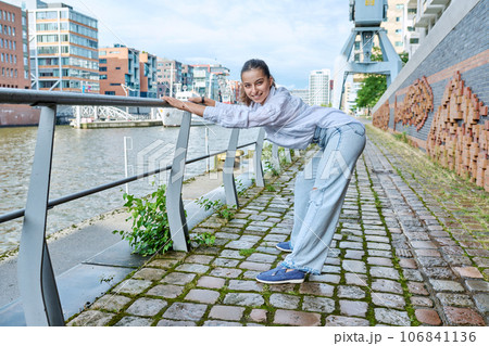 Fashionable young teenage girl posing in a port city Fashionable young teenage girl posing in a port city 106841136