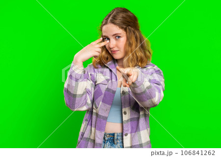 Woman pointing at her eyes and camera show I am watching you gesture spying watching on someone 106841262