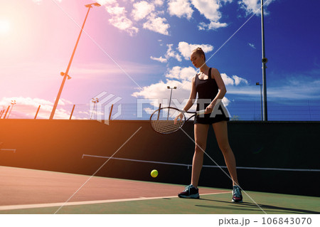 Young woman is playing tennis on the court. Young woman is playing tennis on the court. 106843070
