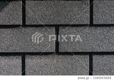 Shingles texture - close up view of asphalt roofing shingles Shingles texture - close up view of asphalt roofing shingles 106843889