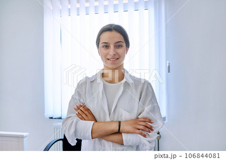 Portrait of smiling teen girl at home near window Portrait of smiling teen girl at home near window 106844081