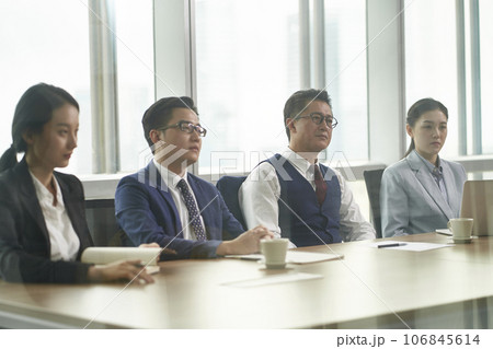 through-the-glass shot of a team of corporate executives meeting in conference room 106845614