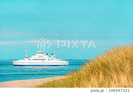 Summer scenery from Sylt island with boat navigating in North Sea, Germany Summer scenery from Sylt island with boat navigating in North Sea, Germany 106847181