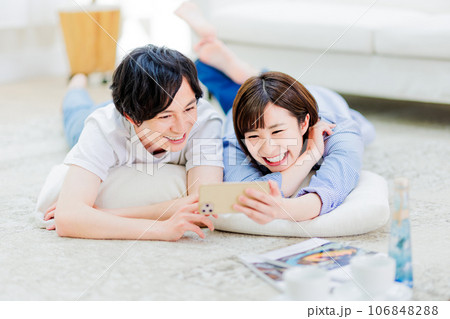 一緒にスマートフォンを見るカップル 106848288