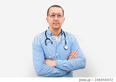 Portrait of a male doctor with a stethoscope looking at the camera on a white background. Portrait of a male doctor with a stethoscope looking at the camera on a white background. 106850072