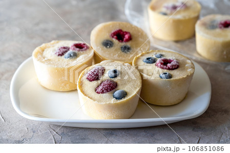 Frozen batter with berries for pancakes are homemade preparation or trendy ice cube pancakes 106851086