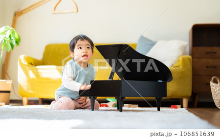 リビングでおもちゃのピアノを弾く3歳の男の子 106851639