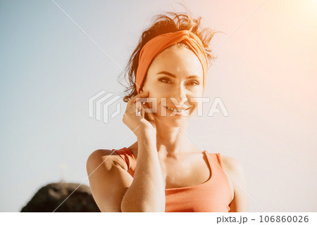 Woman sea yoga. Selective focus. Young beautiful caucasian woman in a red suit practicing yoga on the beach at sunrise near the sea. Yoga. Healthy lifestyle. Meditation concept. 106860026