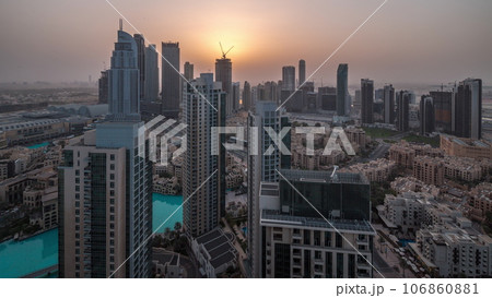 Aerial panoramic view of a big futuristic city night to day timelapse. Business bay and Downtown Aerial panoramic view of a big futuristic city night to day timelapse. Business bay and Downtown 106860881
