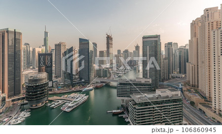Panorama showing overview to JBR and Dubai Marina skyline with modern high rise skyscrapers waterfront living apartments aerial timelapse 106860945