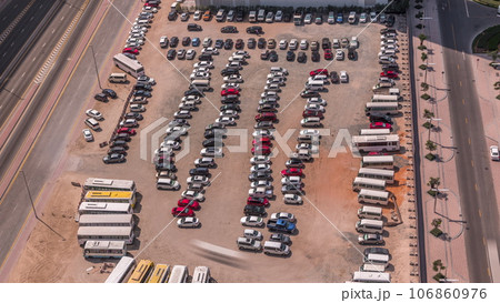 Aerial view of a parking lot with many cars in rows timelapse 106860976