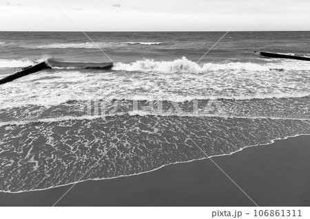 Beach view with shore water and breakwaters 106861311