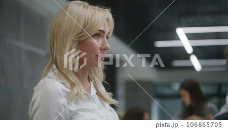 Female receptionist talks with patient at reception desk in clinic Female receptionist talks with patient at reception desk in clinic 106865705