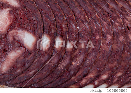 Closeup of thin slices of black botifarra as natural background 106866863