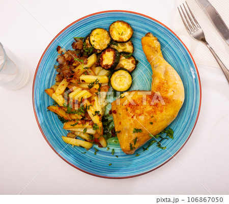 Dish with baked chicken legs and zucchini Dish with baked chicken legs and zucchini 106867050