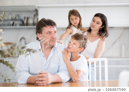 Family with two children in kitchen during quarrel Family with two children in kitchen during quarrel 106867590