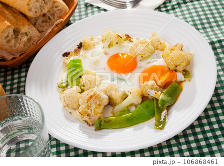 Appetizing cauliflower fried eggs for breakfast Appetizing cauliflower fried eggs for breakfast 106868461