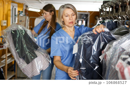 Two women working at dry-cleaning salon 106868527