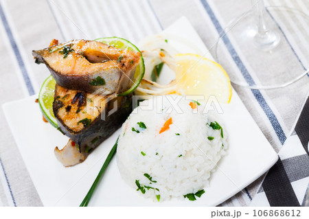 Baked trout steaks with rice 106868612