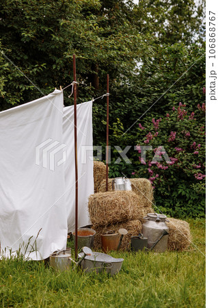 Rural summer day with drying ropes and hay. Rural summer day with drying ropes and hay. 106868767