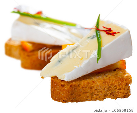 Canape with orange and blue cheese 106869159