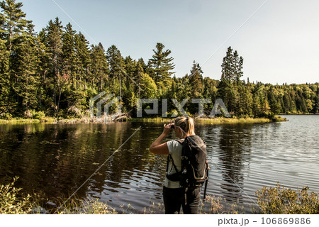 Girl hiking in the Forest near lake in La Mauricie National Park Quebec, Canada on a beautiful day 106869886