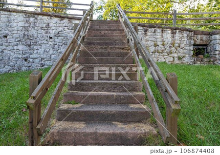 Low angle view up outdoor stone staircase in colonial American village Low angle view up outdoor stone staircase in colonial American village 106874408
