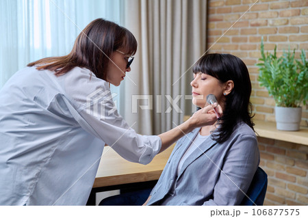 Makeup artist doing makeup for a mature business woman Makeup artist doing makeup for a mature business woman 106877575