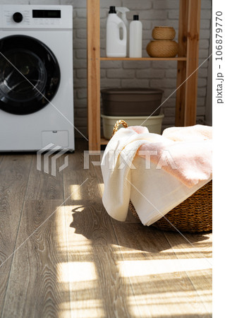 Laundry room with washing machine and basket with laundry Laundry room with washing machine and basket with laundry 106879770