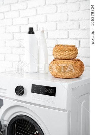 Laundry washing detergents containers on washing machine Laundry washing detergents containers on washing machine 106879804