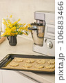 raw chocolate chip cookies on baking sheet ready to bake in oven. kitchen stand mixer background. vertical shot. 106883466