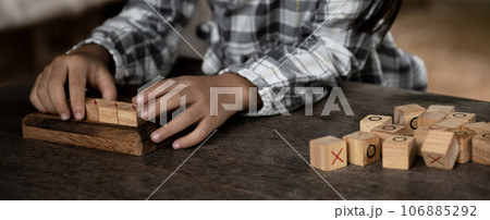 hands kid playing the wooden block game is a way to learn, and develop a way of thinking about concepts, potential and the brain 106885292