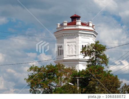 Old water tower. Industrial facility. Against the background of clouds 106888072