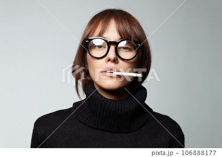 beautiful smoking woman in glasses. pretty serious girl with cigarette 106888177