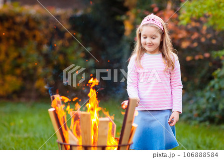 Child with smores at fire. Kids roast marshmallow. 106888584