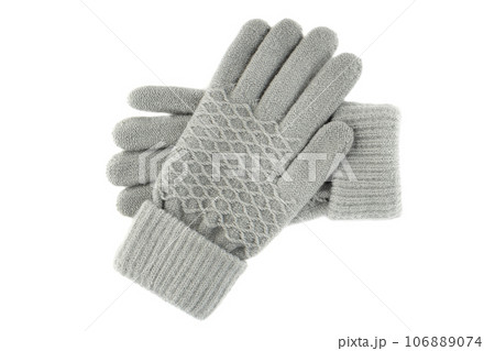 Women's knitted gloves lie one on top of the other on a white background. 106889074