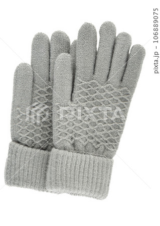 Vertically gray women's knitted winter gloves isolated on a white background. Vertically gray women's knitted winter gloves isolated on a white background. 106889075
